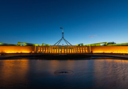 New Parliament House, Canberra, ACT, Australia with Australian flag flying at dusk stock photo